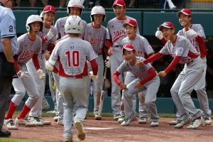 Japan's Keitaro Miyahara (10) is greeted by teammates after hitting a solo home run off Lufkin, Texas' Chip Buchanan in the fourth inning of the Little League World Series Championship baseball game in South Williamsport, Pa., Sunday, Aug. 27, 2017. (AP Photo/Gene J. Puskar).